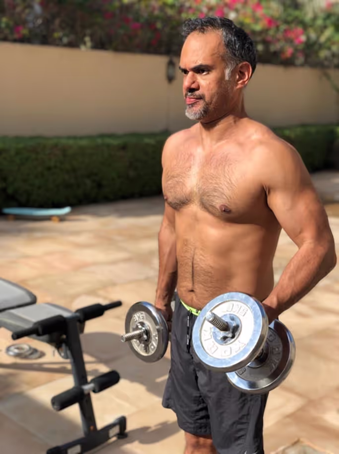 Shaan, a PTD client, after his transformation showing his physique while working out